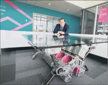  ??  ?? INNOVATIVE Stephen Brownlie with a glass-top coffee table fashioned from a Spitfire engine