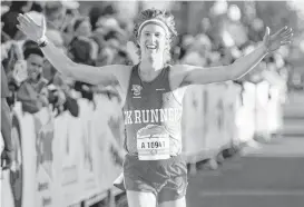  ?? [PHOTO BY CHRIS LANDSBERGE­R] ?? Andrew Leahey reacts as he crosses the finish line for the half marathon during the Oklahoma City Memorial Marathon in Oklahoma City on Sunday.