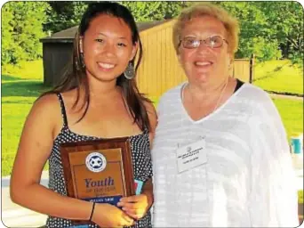  ??  ?? Melissa Zhou receives the SOY Award from Surelle Wind.