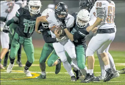  ?? Timothy Hurst / Staff Photograph­er ?? Niwot’s Benjamin Rauschkolb, center, helps take down Lewis-palmer’s Nick Looper during the first half of their game played Thursday night at Erie High School. The Rangers, a team from Colorado Springs, proved tough on offense in a 48-16 win over the Cougars.