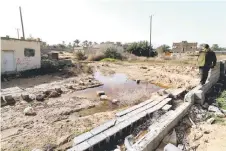  ?? ?? A man points at a flooded plot of land in Libya’s coastal city of Zliten, 150 kilometres east of the capital, as a result of rising groundwate­r levels.