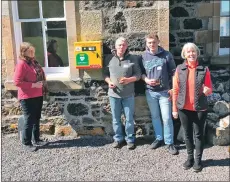  ??  ?? From left: Miranda Morris, Davy Shaw, Ross Shaw and Barbara Campbell beside the newly-installed defibrilla­tor.