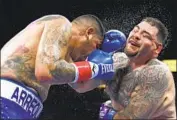  ?? Harry How Getty Images ?? ANDY RUIZ JR., right, survived a knockdown for a unanimous decision over Chris Arreola on Saturday.