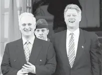  ?? ?? Then U.S. President Bill Clinton, right, laughs with then Irish Prime Minister John Bruton, left, on Dec. 1, 1995, before a meeting in which they discussed Bosnia and the Northern Ireland peace process. AFP-TNS