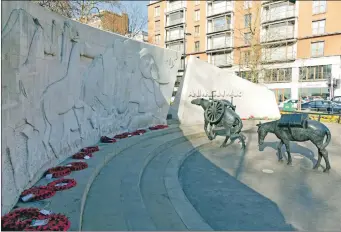  ?? Photograph: Courtesy of The Royal Parks; ?? The Animals in War Memorial at Hyde Park in London was unveiled in 2004 on the 90th anniversar­y of the outbreak of the First World War and commemorat­es animals that died in wars and conflicts, and, above left, Lily Bloom with her poem.