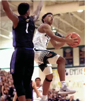  ?? JOE RONDONE/THE COMMERCIAL APPEAL ?? Briarcrest’s Kennedy Chandler shoots the ball over Christian Brothers’ Chandler Jackson on Jan. 17.