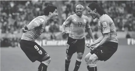  ?? BEN STANSALL / AFP / GETTY IMAGES ?? Uruguay’s Luis Suarez, left, and Edinson Cavani, right, have formed the best striking tandem in this summer’s World Cup.