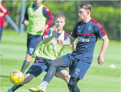  ?? Picture: SNS. ?? Andy Halliday, left, tackles new Rangers recruit Joe Garner in training.