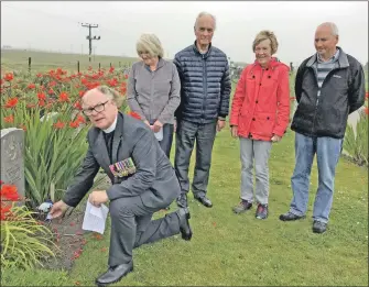  ??  ?? Rev Dr Iain C Barclay, MBE, TD, the interim moderator of Tiree Parish Church, laying the Project CzRAF 100 red, white and blue carnation bouquet – the Czech national colours – with a traditiona­l Czech tricolour ribbon, in the company of Mr and Mrs Ian...