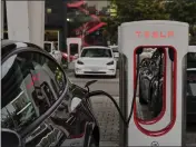  ?? PHILIP CHEUNG — THE NEW YORK TIMES, FILE ?? A Tesla Supercharg­er electric-vehicle charging station in Santa Monica. Tesla sales fell sharply last quarter as competitio­n increased worldwide.