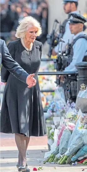  ?? Picture Paul Grover ?? King Charles III and Queen consort Camilla view floral tributes to the late Queen at Buckingham Palace on Friday