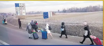  ?? ?? A GROWING CRISIS - People cross the border from Ukraine into Poland this week. UNICEF calls for an immediate cease-fire and reminds all parties of their internatio­nal obligation­s to protect children from harm and ensure that humanitari­an actors can safely and quickly reach children in need.