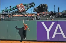  ?? Leah Millis / The Chronicle ?? Against the outfield wall, Edward Vaquerano catches a ball thrown by friends during Giants FanFest at AT&amp;T Park.