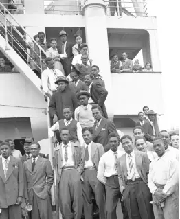  ?? AP ?? In this June 22, 1948 file photo, Jamaican men, mostly ex-Royal Air Force servicemen, pose for a photo aboard the former troopship ‘SS Empire Windrush’ before disembarki­ng at Tilbury Docks, England.