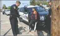  ?? BEA AHBECK/NEWS-SENTINEL ?? Lodi Police Officer William Hinton and Sgt. Tim Fritz talk to a woman as they detain her as Hinton works his shift in Lodi on Thursday morning.