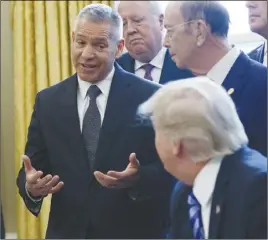  ?? AP PHOTO ?? TransCanad­a CEO Russell K. Girling speaks to President Donald Trump in the Oval Office of the White House in Washington during an announceme­nt on the approval of a permit to build the Keystone XL pipeline.