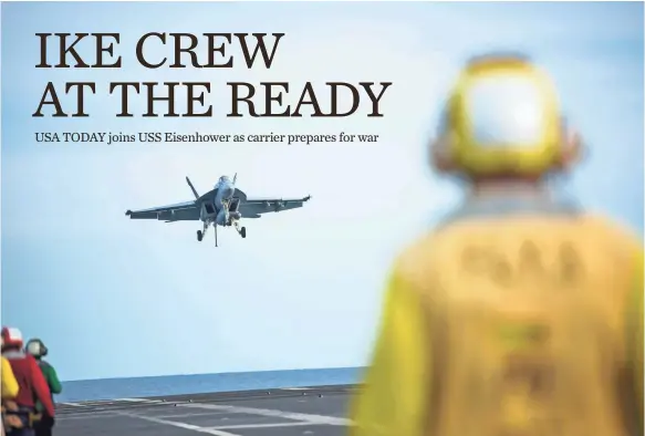  ?? PHOTOS BY JACK GRUBER, USA TODAY ?? Aircraft handlers watch as an F/A-18E Super Hornet approaches the deck of the USS Eisenhower, which serves as a deterrent to threats in the Mediterran­ean.