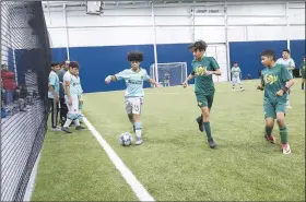  ?? NWA Democrat-Gazette/CHARLIE KAIJO ?? Soccer players from Helen Tyson Middle School and the Manchester Soccer Club play Saturday at the Springdale Recreation Center in Springdale.