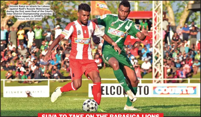  ?? Picture: BALJEET SINGH ?? Sitiveni Rakai on attack for Labasa against Nadi’s Rusiate Matererega during the first semi-final of the Courts Inter District Championsh­ip yesterday. More reports in SPORTS.