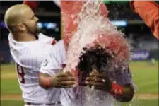  ?? MATT SLOCUM — THE ASSOCIATED PRESS ?? Philadelph­ia Phillies’ Maikel Franco, right, is doused by Cameron Rupp after Franco had a game-winning two-run hit during the 10th inning of a baseball game against the Atlanta Braves, Saturday in Philadelph­ia.