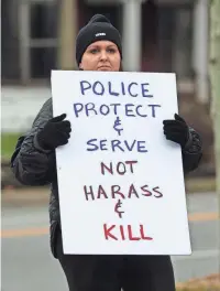  ?? SAM UPSHAW JR./COURIER JOURNAL ?? Jaime Hendricks holds up a sign during a protest at the corner of Broadway and Baxter
Avenue in Louisville, Ky., on Jan. 29. Local activists participat­ed in a march to honor Tyre Nichols, who was killed by police officers in early January in Memphis.