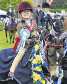  ??  ?? Clean sweep . . . Brin Millar (6), of Outram, beams atop pony Silverbank Melemisa, having won almost more prizes than they could both carry.