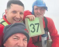  ??  ?? Elfed Williams, left, who had his hair cut on top of Snowdon, with barber Jason Parry and Gerald Parry