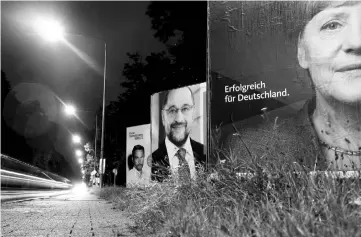  ??  ?? Election campaign posters for the upcoming Germany’s general elections of the Christian Democratic Union party (CDU) with a headshot of Merkel with Schulz and Free Democratic Party (FDP) top candidate Christian Lindner are photograph­ed with long...
