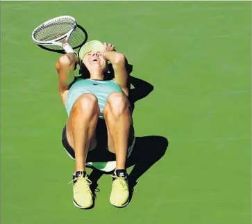  ?? Clive Brunskill Getty Images ?? ELENA VESNINA is overcome with emotion after claiming the title at the BNP Paribas Open. Vesnina, who also is a skilled doubles player, will rise to a career-best 13 in the next world rankings.