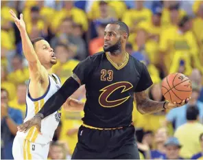  ?? BOB DONNAN, USA TODAY SPORTS ?? Stephen Curry, left, guards LeBron James in last year’s Finals, won by the Cavs.