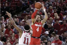  ?? NATI HARNIK — THE ASSOCIATED PRESS ?? Ohio State’s Duane Washington Jr. shoots over Nebraska’s Dachon Burke Jr. during a game in Lincoln, Neb.