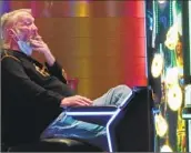  ?? Wayne Parry Associated Press ?? A GAMBLER SMOKES while playing a slot machine in the Ocean Casino Resort in Atlantic City, N. J.