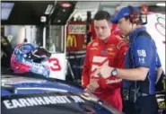  ?? JIM COLE — THE ASSOCIATED PRESS ?? Alex Bowman, left, talks with a crew member while filling in for Dale Earnhardt Jr. in July of 2016. The 24-year-old Bowman was named to replace the retiring Earnhardt in No. 88 car next season.