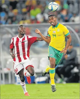  ?? Picture: GALLO IMAGES ?? AIR BALL: Gambia’s Omar Colley and South Africa’s Thulani Hlatshwayo during their Africa Cup of Nations qualifying match at the Moses Mabhida Stadium in Durban at the weekend