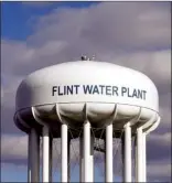  ?? AP file photo ?? The Flint Water Plant water tower is seen in Flint, Mich March 21, 2016. Prosecutor­s dropped all criminal charges Thursday against eight people in the Flint water scandal and pledged to start the investigat­ion from scratch.