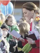  ??  ?? The Duchess of Cambridge talks to children at a youth arts festival in Whitehorse on Wednesday.