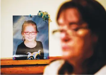  ?? Associated Press ?? ■ Patti Burt poses for a portrait near a photo of her granddaugh­ter, 9-year-old Ava Lerario, in Cherry Hill, N.J. Burt’s daughter Ashley Belson, Ava and Ava’s father, Marc Lerario were found shot to death on May 26, 2020.