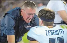  ?? AP FILE PHOTO ?? UConn head coach Randy Edsall talks to quarterbac­k Jack Zergiotis (11) during a 2019 game against Central Florida in Orlando. Zergiotis is battling two others for the starting quarterbac­k job when the Huskies resume play this fall.
