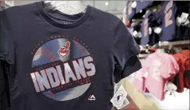  ?? AP file photo ?? A Cleveland Indians T-shirt with the Chief Wahoo logo hangs at the team shop on Jan. 29, 2018, in Cleveland. The team — which dropped the Chief Wahoo image from its caps and jerseys last year but continues to sell items with the controvers­ial cartoonish figure — will be changing its name, with owner Paul Dolan saying “it’s time.”