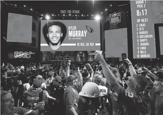  ??  ?? Fans react after Oklahoma quarterbac­k Kyler Murray is selected as the No. 1 pick in the first round by the Cardinals during the 2019 NFL Draft in Nashville, Tenn.