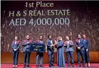  ?? — Supplied photo ?? Senior executives of H&amp;S Real estate receive the award from emaar chairman Mohamed Alabbar in Dubai.