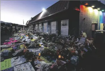  ?? PARKER SEIBOLD/THE GAZETTE VIA AP ?? Mourners gather outside Club Q to visit a memorial in 2022, in Colorado Spring, Colo.