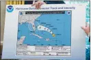  ?? ERIN SCHAFF / NEW YORK TIMES FILE (2019) ?? President Donald Trump holds up a chart of Hurricane Dorian’s expected path, with an additional space drawn in to include a portion of Alabama, during a briefing Sept. 4, 2019, in the Oval Office.