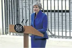  ?? DAN KITWOOD/GETTY IMAGES ?? British Prime Minister Theresa May speaks outside 10 Downing St. after returning from Buckingham Palace on Friday in London, England. May’s Conservati­ve Party lost their majority in Thursday’s election.