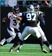  ?? ANDY CROSS — THE DENVER POST ?? Denver Broncos quarterbac­k Russell Wilson (3) scrambles out of the pocket as Denver Broncos offensive tackle Calvin Anderson (76) blocks Carolina Panthers defensive end Yetur Gross-matos (97) in the second quarter at Bank of America Stadium in Charlotte, N.C., on Nov. 27, 2022.