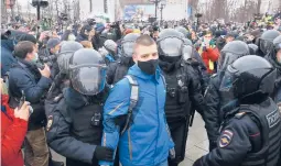  ?? PAVEL GOLOVKIN/AP ?? Police detain a man during a protest Saturday against the jailing of opposition leader Alexei Navalny in Moscow. About 15,000 demonstrat­ors gathered in the city.