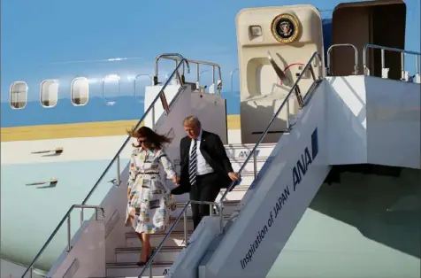  ?? Koji Sasahara/Getty Images ?? President Donald Trump and first lady Melania Trump arrive at Haneda Internatio­nal Airport on Saturday in Tokyo for a four-day state visit. On Monday, Mr. Trump will meet Japan’s new emperor, Naruhito.