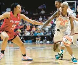  ?? SARAH GORDON/AP ?? Connecticu­t Sun guard Courtney Williams (10) looks to move past Atlanta Dream forward
Naz Hillmon (00) during a WNBA game Wednesday night in Uncasville. The Sun won 105-92 to move their record to 11-4.