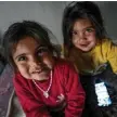  ?? ?? The daughter of Danisma, pose for a photograph inside their container home, housing the victims of the February 2023 earthquake, in Antakya, in Hatay province.