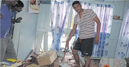  ?? Photo: Simione Haravanua ?? Rohit Anand points at the spot where he was sleeping when the car hit their house on July 20, 2018.